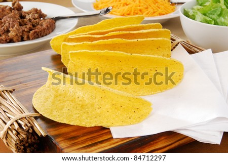 Taco shells and the fixing laid out on a buffet