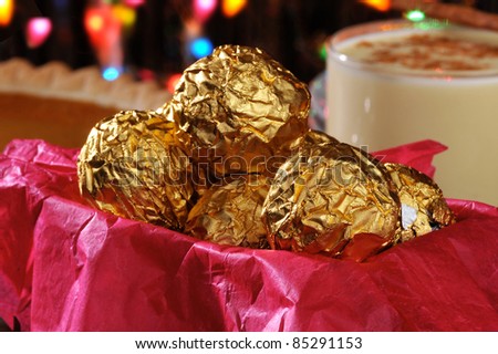 A gift box of chocolates on Christmas with eggnog and a pumpkin pie in the background