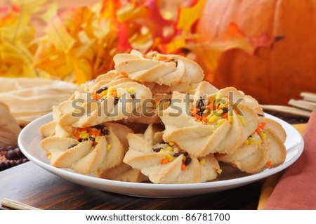Shortbread cookies with orange and yellow candy sprinkles in a festive autumn or fall holiday setting