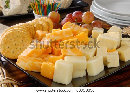 A plate of cheese and crackers on a party buffet table