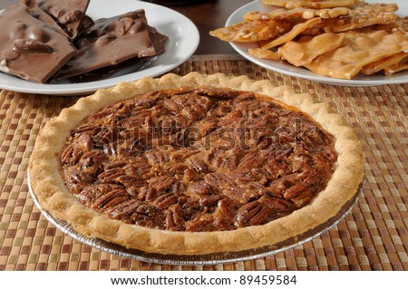 A pecan pie with peanut brittle and chocolate almond bark
