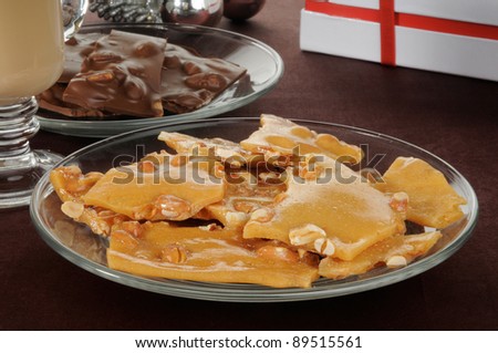 A plate of peanut brittle with chocolates, hot cocoa and Christmas ornaments