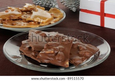 A plate of gourmet chocolate bark with almonds and peanut brittle