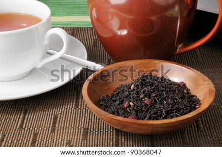 A cup of whole leaf blac tea with pomegranate