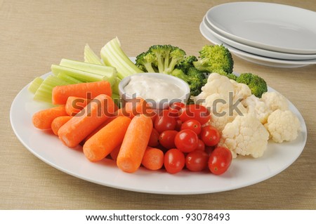A party plate loaded with vegetables and ranch dressing