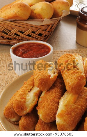 a plate of deep fried breaded mozzarella cheese sticks