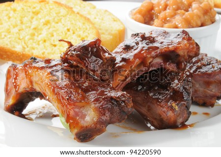 Close up of a plate of ribs with baked beans
