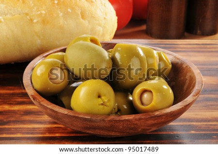 a bowl of green olives stuffed with anchovies