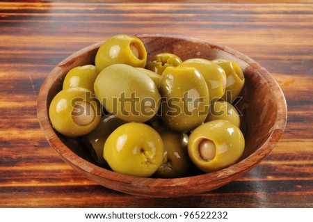 A bowl of green olives stuffed with anchovies