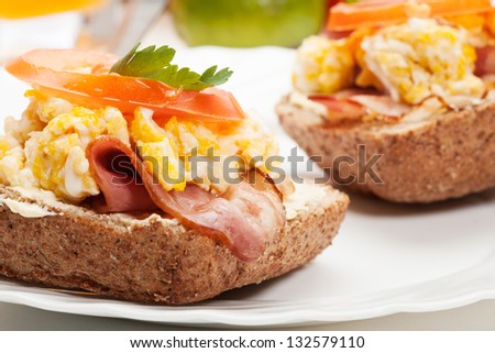Sandwich with scrambled eggs and bacon. Selective focus.