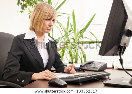 Worried businesswoman working with computer