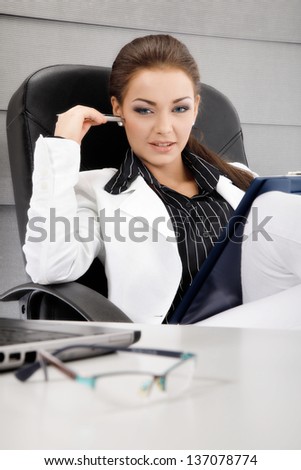 Businesswoman workig in the office. Focus on face