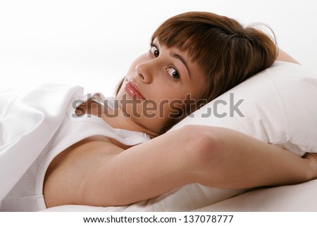 Beautiful young girl thinking in bed