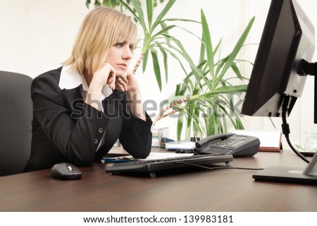 Worried businesswoman working with computer