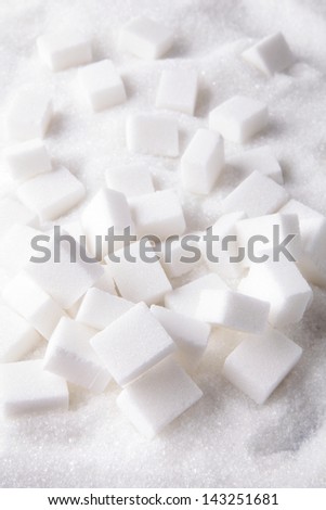 Sugar lumps on sugar background