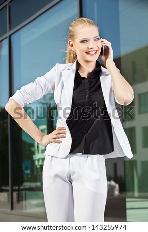 Young businesswoman at phone in an urban setting