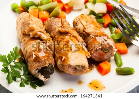 Beef rolls and vegetables on plate