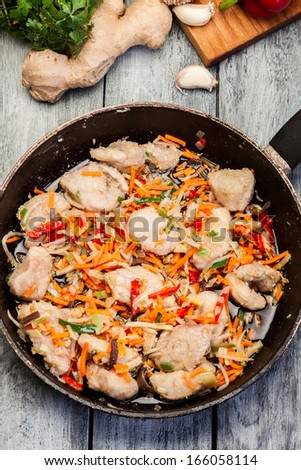 Pork in Chinese with vegetables in a wok pan