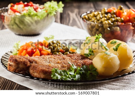 Breaded cutlet and prepared potatoes