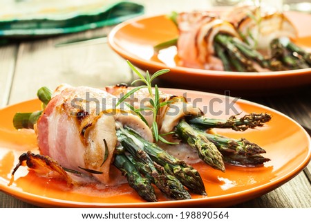 Baked fresh asparagus wrapped in chicken and bacon