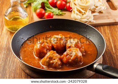 Meatballs with tomato sauce on pan