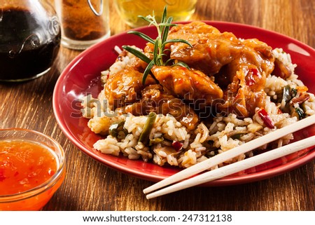 Fried chicken pieces with rice and sweet and sour sauce
