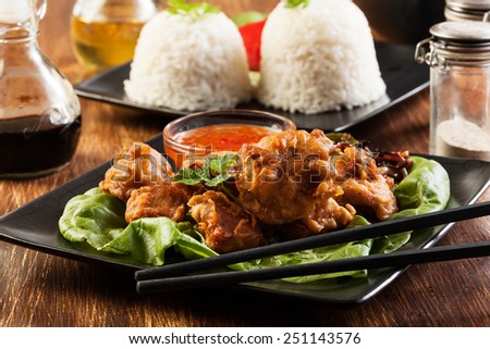 Fried chicken pieces in batter on a plate