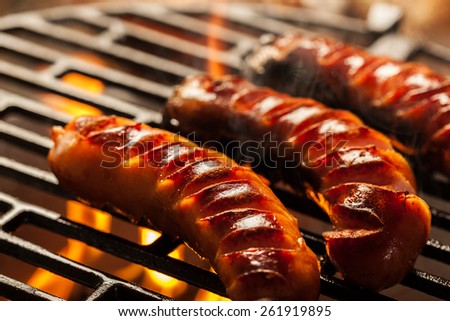 Grilling sausages on barbecue grill. Selective focus