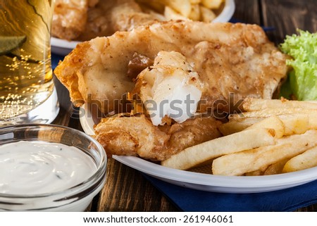 Traditional fish and chips with tartar sauce on a plate