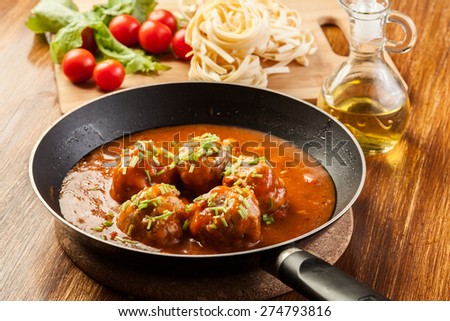 Meatballs with tomato sauce on pan
