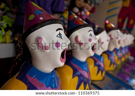 row of clown heads, turning away from camera