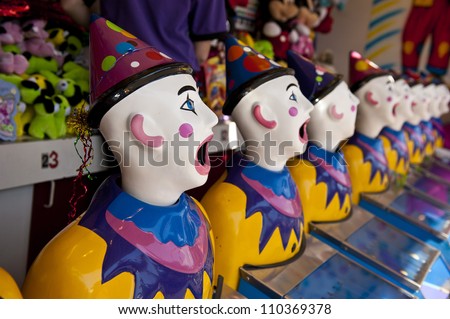 row of clown heads, turning away