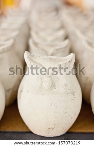 a row of clay owls, homeware or garden decoration