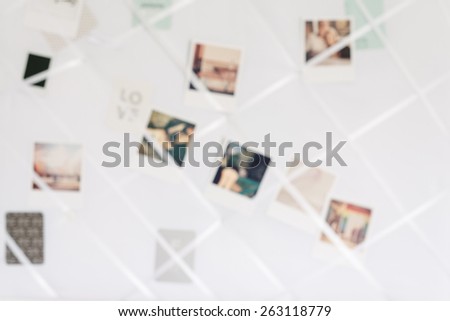 blurry image of polaroids in a white memory board