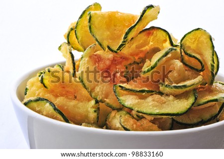 a bowl of zucchini chips, yummy alternative to potato chips - no less fattening though, don't kid yourself! white background, close up.