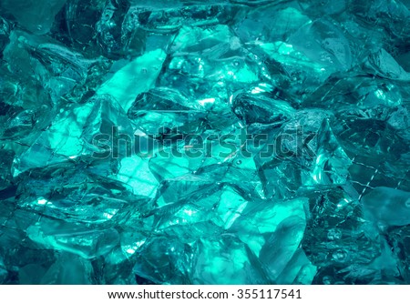 Gentle teal fond of sparkling water-washed grained rock with jagged edges, mysteriously lit cerulean celeste cyan glow. Closeup view with space for text