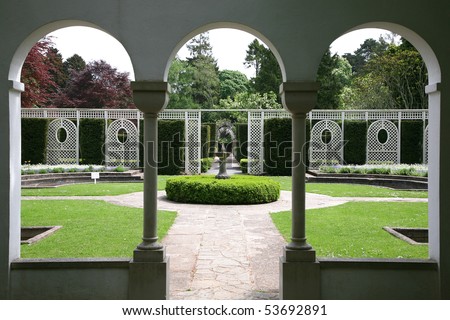 view of formal garden through arched windows