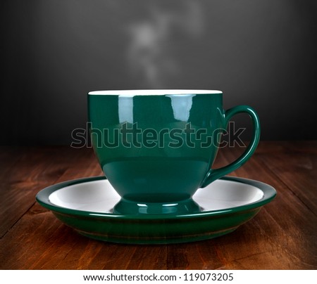 cup of tea on wood table with smoke