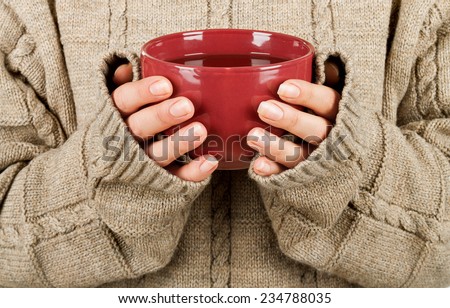Female hands with hit drink