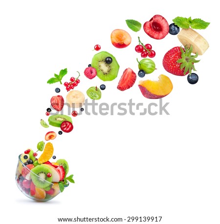 fruit salad ingredients in the air in a glass bowl isolated on white background