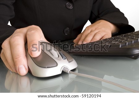 computer mouse in hand with keyboard and reflection