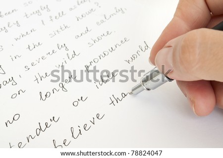 hand with pen writing on the sheet