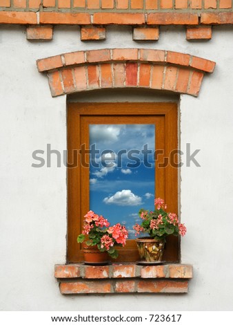 Window with flowers from Outside view of Old House. Blue Sky with Clouds inside...