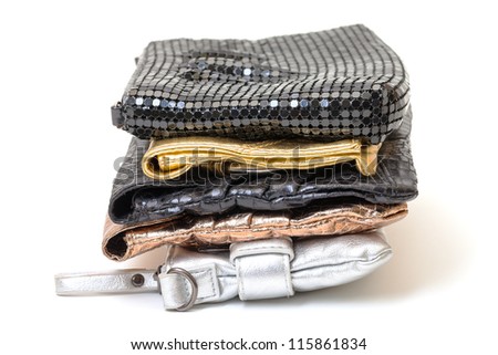 Selection of four leather evening bags in black, silver and two shades of gold with different designs and styles on a white background