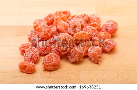 Sweet dry kumquat fruit on wooden background