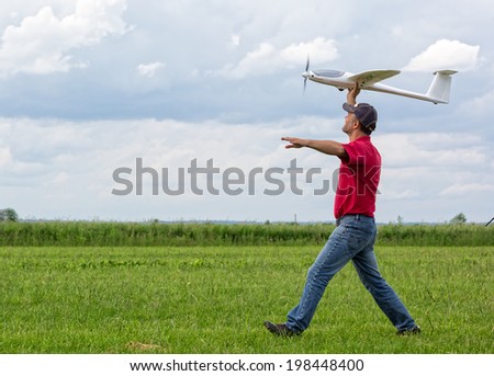 Man launches into the sky RC glider, blue sky background