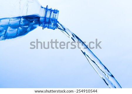 Cool Water Pouring from a Transparent Plastic Bottle, close up