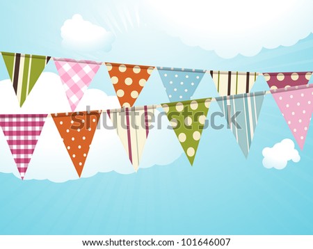 Bunting against a blue sky with fluffy clouds