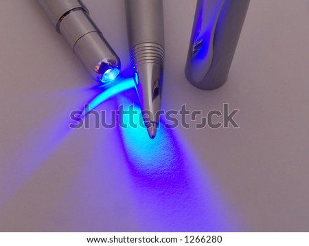 macro photo of silver pen lit by uv light