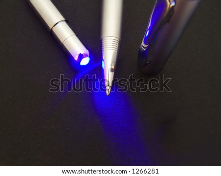 macro photo of silver pen lit by uv light
